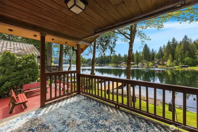 Covered deck with easy access to side deck area and lower yard/dock.