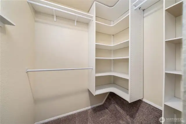 Large walk in closet with custom shelving.