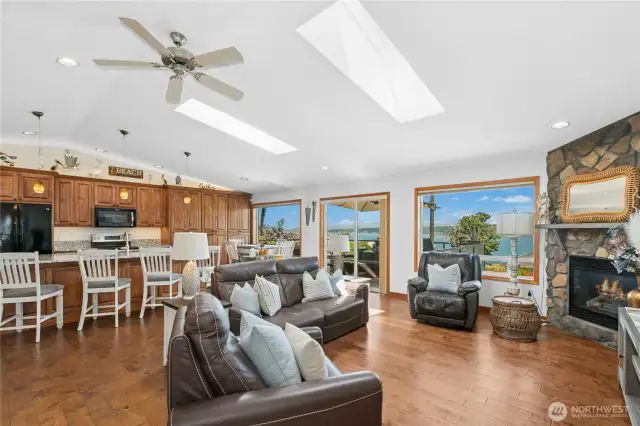 Bright, inviting living space boasts wall-to-wall windows that capture the changing light and ever-present mountain and water views.