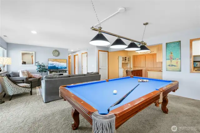 The lower level comes complete with a pool table, perfect for friendly games, gatherings, and fun.
