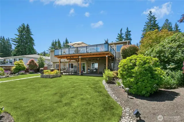 A custom pond and peaceful water feature add calming sound and visual serenity to the garden’s ambiance.