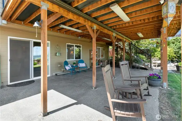 A weather-protected patio beneath the Tek Dek deck is outfitted with custom dimmable lighting for all-weather relaxation and entertaining.