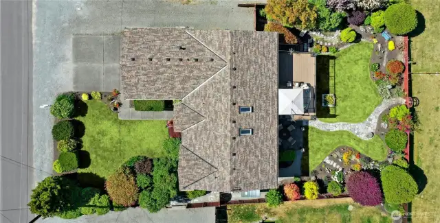 A stunning aerial reveals the new, multicolored 50-year architectural roof and beautifully landscaped, fully fenced grounds that frame this extraordinary retreat.