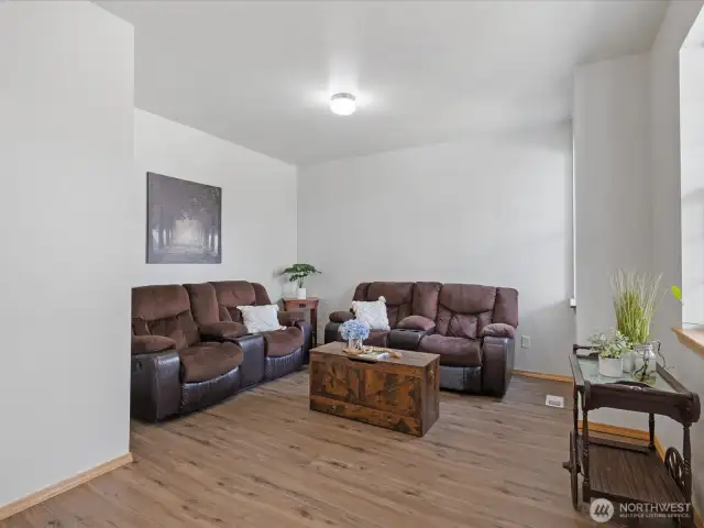 Step inside to a freshly painted interior that feels light and bright, where large windows flood the home with natural light.