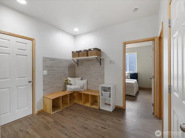Function meets design in the spacious mudroom, complete with built-in bench seating and storage cubbies.