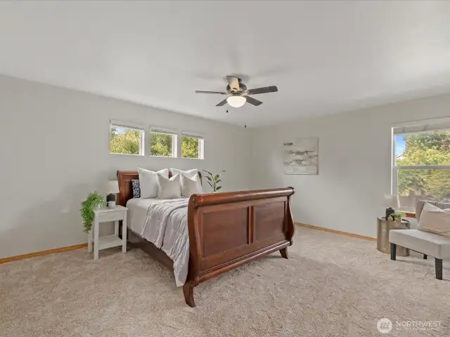 Upstairs, the massive primary suite serves as a private retreat.