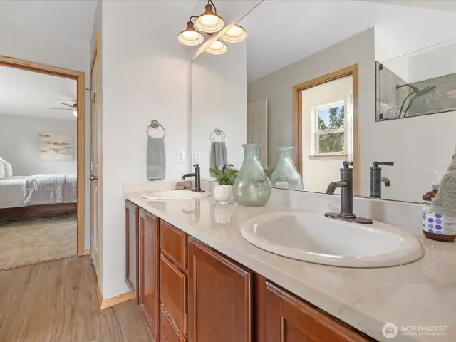 The en suite bathroom is generous in size, offering dual vanities, soaking tub, separate shower, and a large walk-in closet.