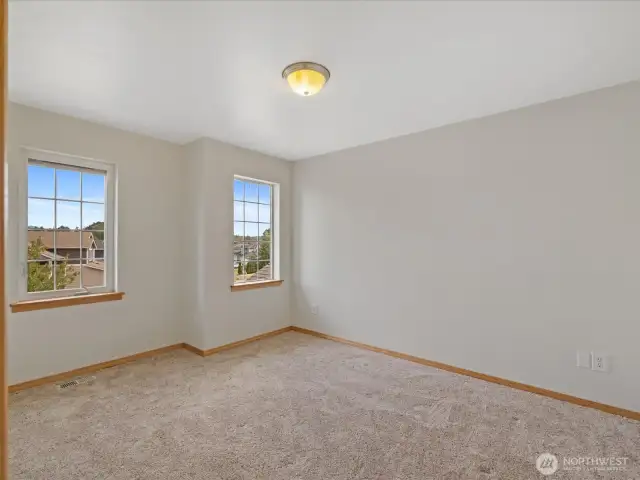 Two more oversized bedrooms upstairs provide plenty of room for family, guests, or home offices.