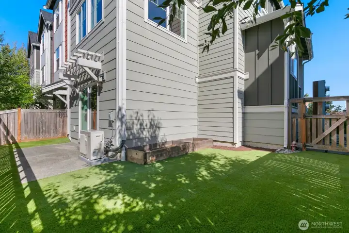Fully fenced back yard with raised beds and low maintenance turf! HOA cares for front landscaping.