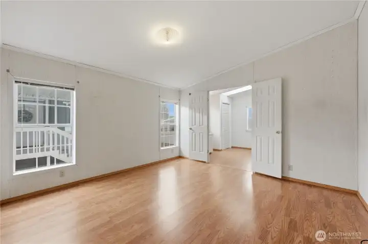 Primary bedroom with french doors into primary bath