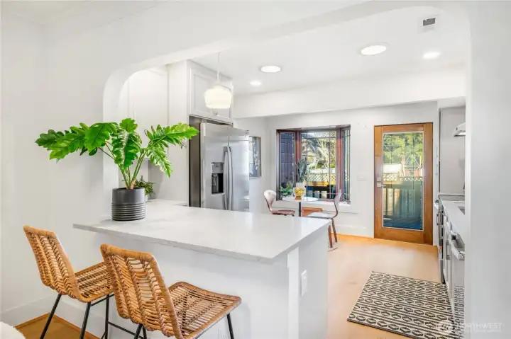 Newly renovated kitchen to the studs... New cabinetry, flooring, counters, tile and appliances... Classic and timeless design and aesthetic. A kitchen pass through was created between the dinning room and kitchen creating an eat-at counter top bar and better function and work space.