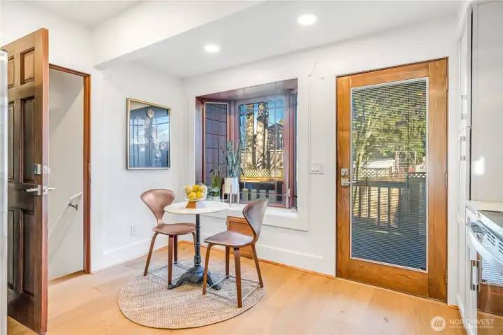 In-kitchen breakfast nook, bay window and access to the back deck and fenced yard.