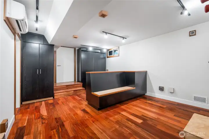 Built-in storage and Murphy bed for guests or late night jam sessions... Center console and seating fixture is multi purpose for control and mixing. Back side can be used for storage or sound equipmment rack.  Lower level was dugout two feet to provide better head height. New slab foundation and steel support beam runs the length of the renovated basement.