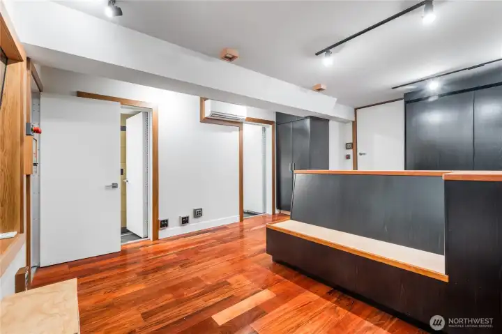 view from the front recording area to the stairwell up to the main level (fully isolated sound proof doors) plus a 3/4 bathroom to the left.