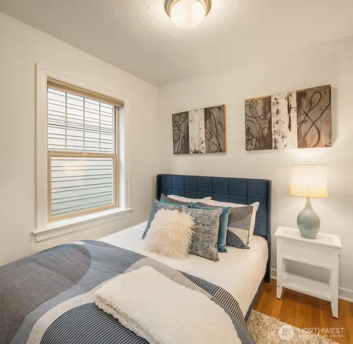 Efficient bedroom accommodates a queen bed.
