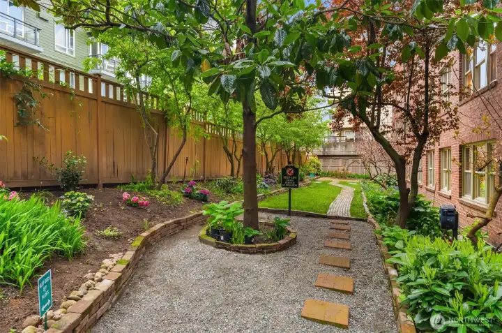 Community garden east of building includes patio space.
