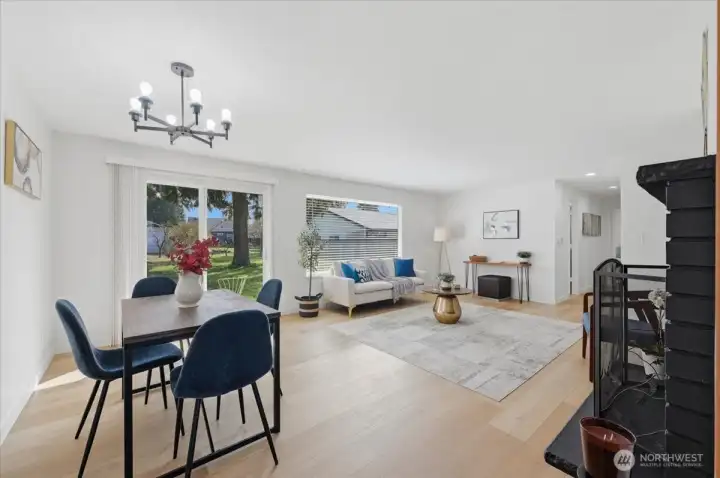 Living room with new luxury vinyl plank flooring throughout. Sliding door leads the backyard oasis. Light and bright!