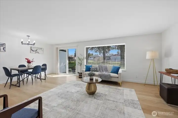 Spacious living room with luxury vinyl plank flooring and new interior paint throughout.