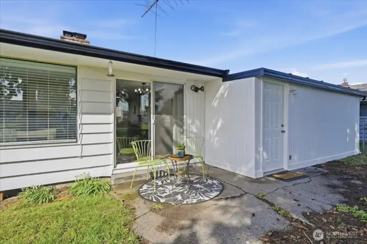 Back patio area off the living room.  Door on the right leads into the shop area off the carport/garage.