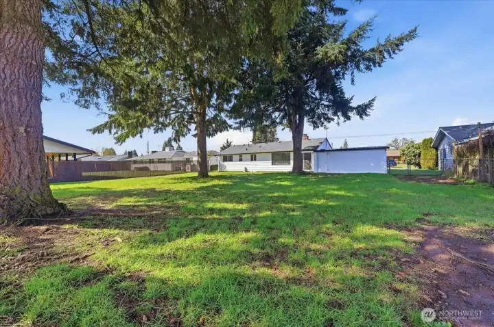 Large level backyard is fully fenced and offers alley access in back.