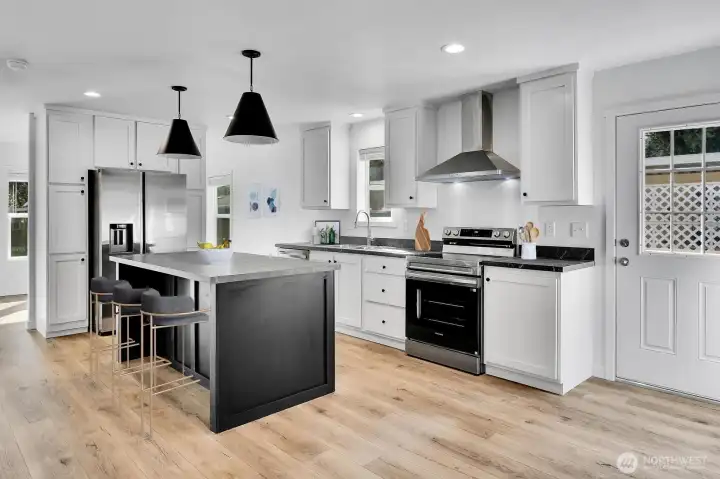 Kitchen with all stainless steel appliances and soapstone tops