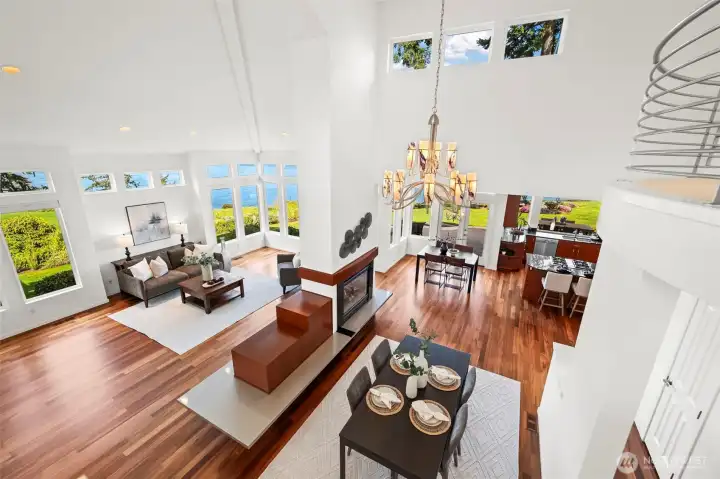 From the staircase you can see the entire great room including the kitchen, together with the modern light fixtures and creative windows.