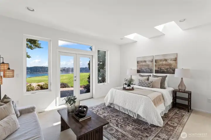 Designed for long term living / forever home, the primary bedroom is on the main floor, featuring french doors to the patio and its own sitting area.