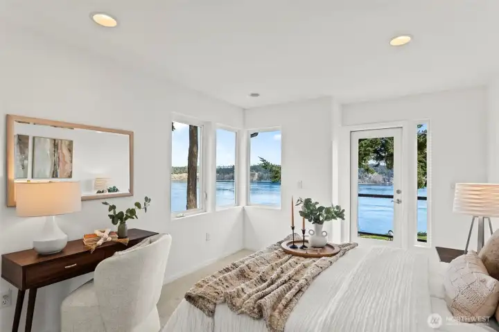 The two guest bedrooms on the upper level are mirror images designed to showcase the wate views, with doors to an upper deck.