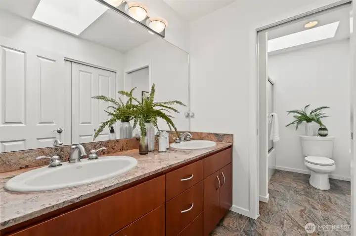 The full bath on the upper level is well appointed with marble counters and floors.