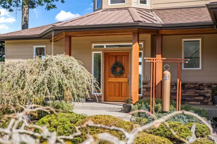 Inviting entry featuring a hand crafted gong that will convey with the house (created by the owner, a metal artist, on side in the the 3rd bay of the garage (turned shop).  The homes 3164 sf does not count the 600 sf on the lower level that is roughed in with an egress window and ready for your vision.