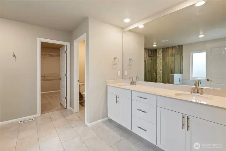 Quartz counters, double sink, toilet closet and spacious walk in closet.