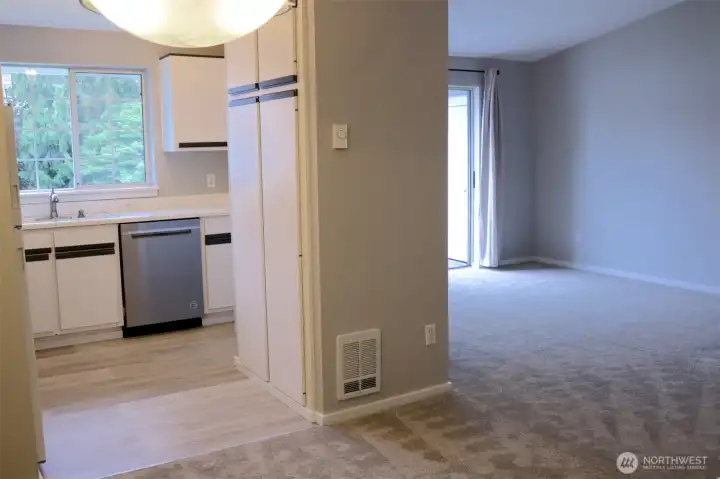 from the dining room, looking into the kitchen and living room towards deck
