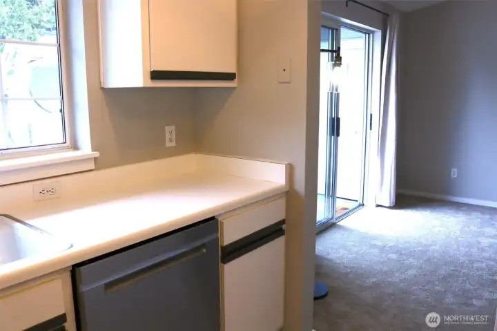 kitchen with dishwasher looking toward living room