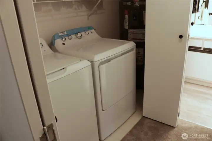 washer, dryer and hot water heater in hall closet