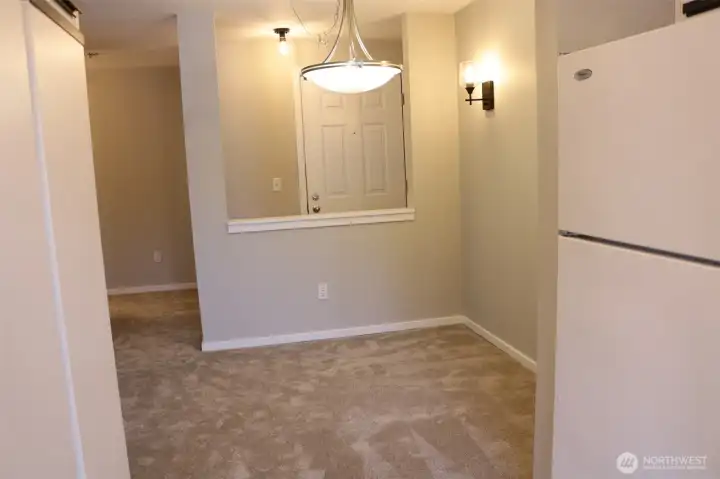 dining room from the kitchen, updated light fixtures, new paint and new carpet