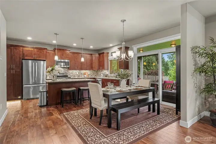 View of your dining room and kitchen from the family room. True open-concept living here in the rear of the home. The size of the patio doors will surprise you!