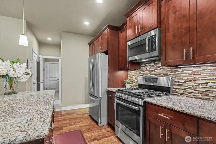View of your kitchen looking down the hall to your walk-in pantry and garage, like cooking with gas?? Me too!