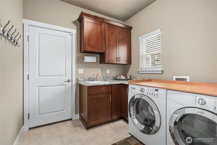 FINALLY, a nice utility room! Folding table, sink and cabinetry, plus an outdoor window, makes what used to be a chore actually enjoyable.