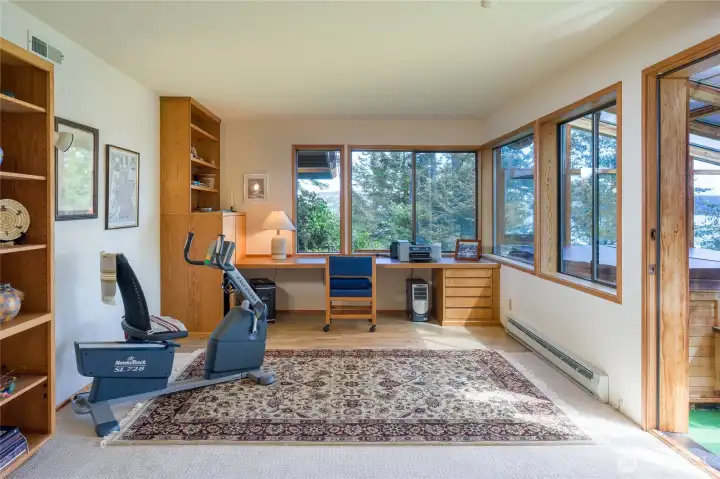 Lower level office with built-in book shelves and desk.