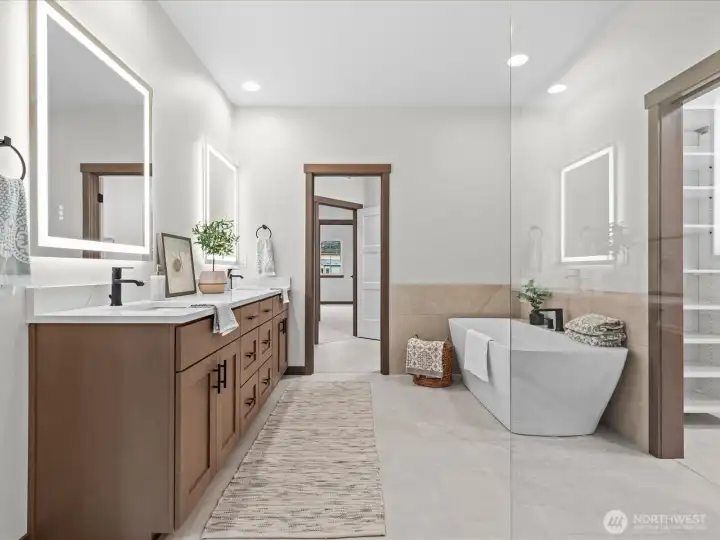 Spa-inspired primary bathroom highlighting the sleek double vanity, modern freestanding tub, and premium tile finishes.