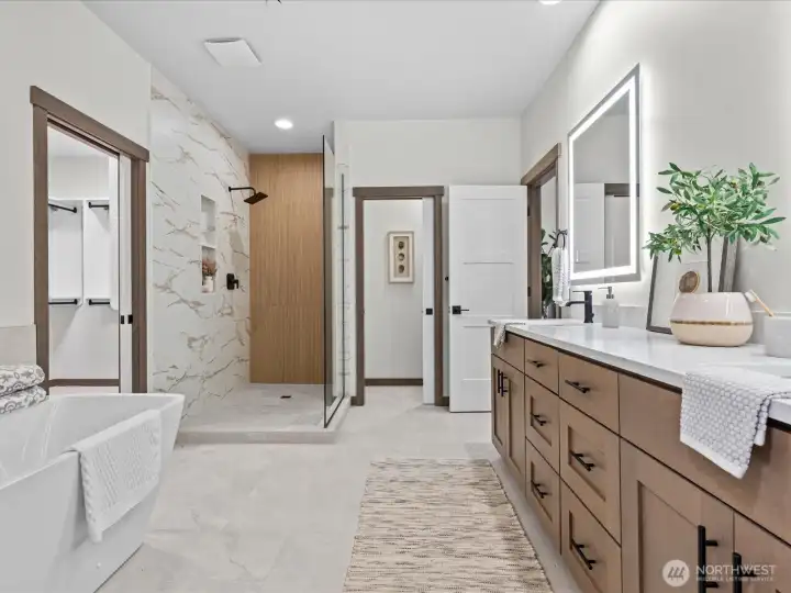 Another view of the gorgeous primary bath, showcasing the generous double vanities, standalone soaking tub, and seamless transition to the walk-in shower.