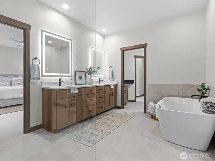 Gorgeous stand alone tub, double sinks with slab counter tops and vanities with walk in shower.