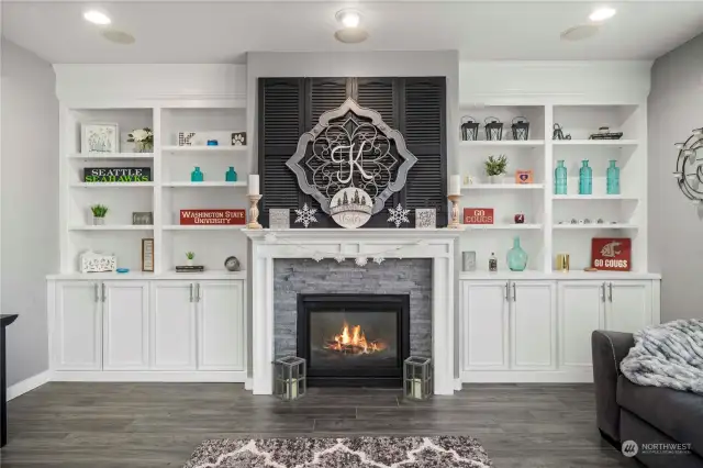 Family room with a beautiful wall of built in cabinetry with gas fireplace.