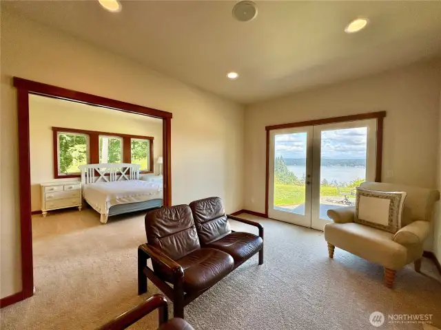 The main floor primary bedroom (one of 2 primary bedrooms) has a fireplace, sitting room, walk-in closet, patio access & ensuite.