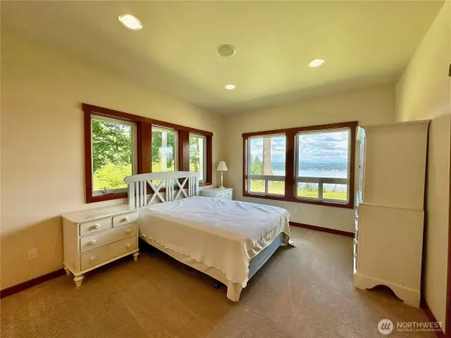 The main floor primary bedroom (one of 2 primary bedrooms) has a fireplace, sitting room, walk-in closet, patio access & ensuite.