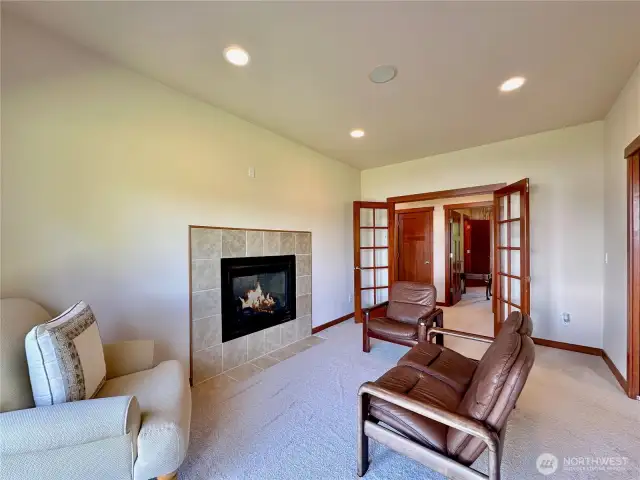 The main floor primary bedroom (one of 2 primary bedrooms) has a fireplace, sitting room, walk-in closet, patio access & ensuite.