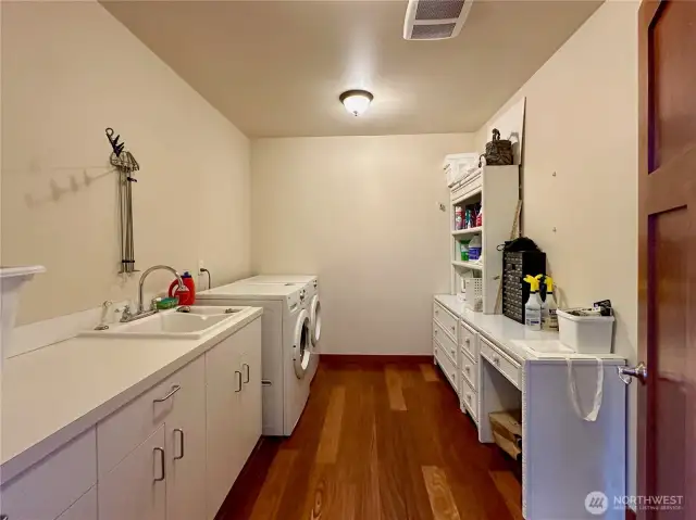 The laundry room with sink and lots of storage.