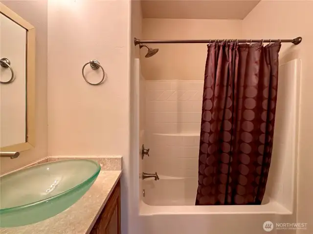 The second main floor bedroom has its own full bath.