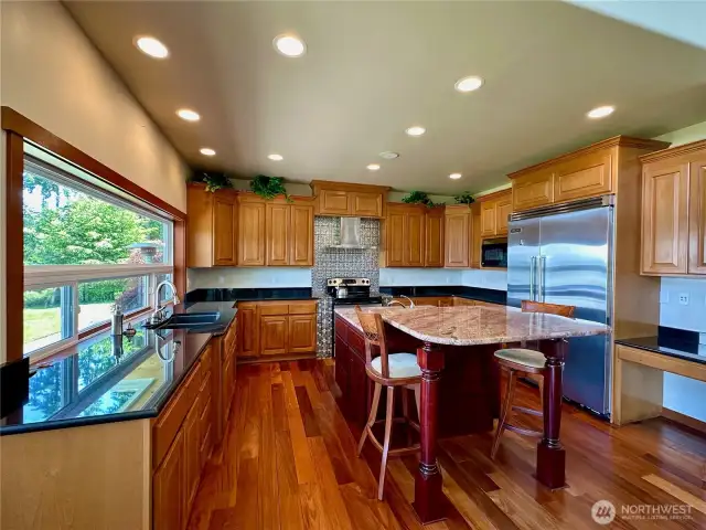The kitchen has a large window open to the view, granite countertops and a large kitchen island.