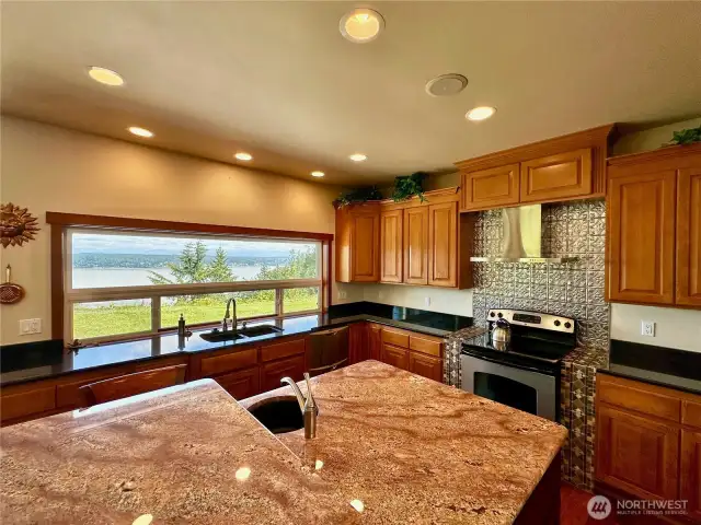The kitchen has a large window open to the view, granite countertops and a large kitchen island.